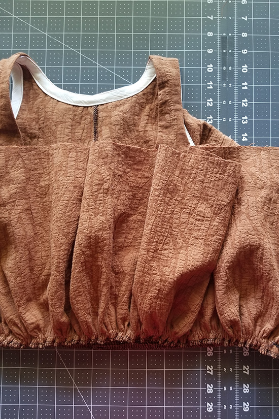 First tier caramel colored dress is placed right sides together with the bodice and stitched.