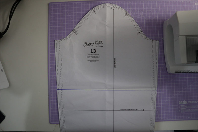 Orchid sleeve pattern piece shown on cutting mat.