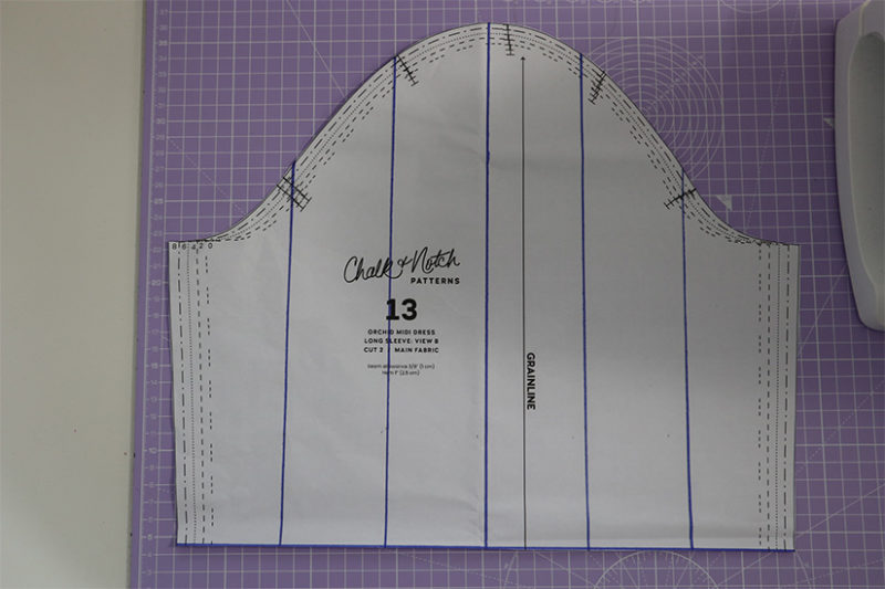 Orchid Midi sleeve pattern piece is shown with vertical lines drawn in blue. 