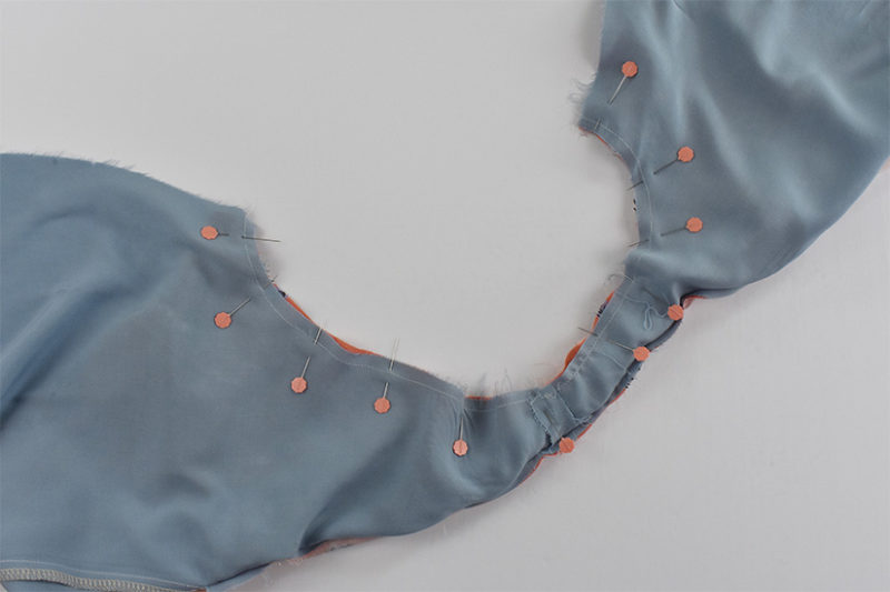 The armhole is shown pinned with main and lining right sides together.