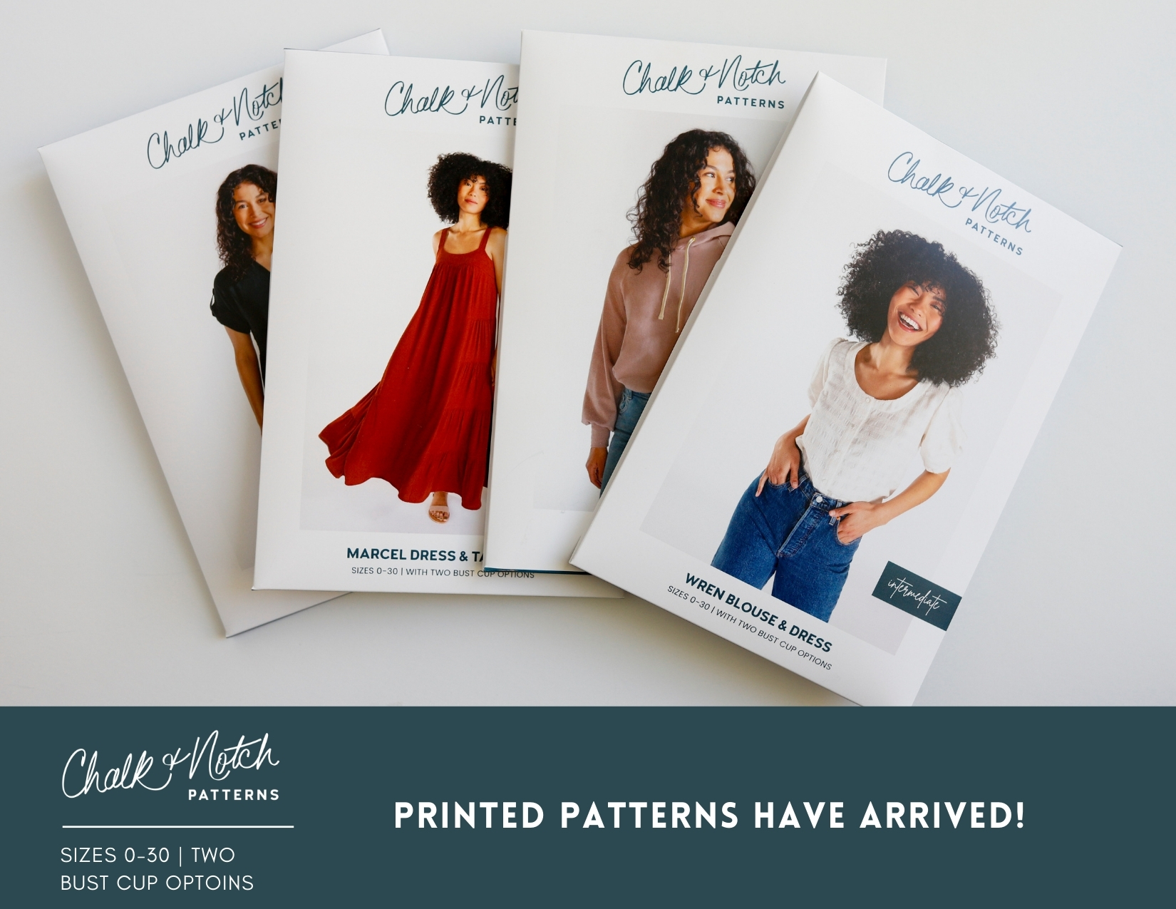 A flat lay of the envelopes of four printed sewing patterns.