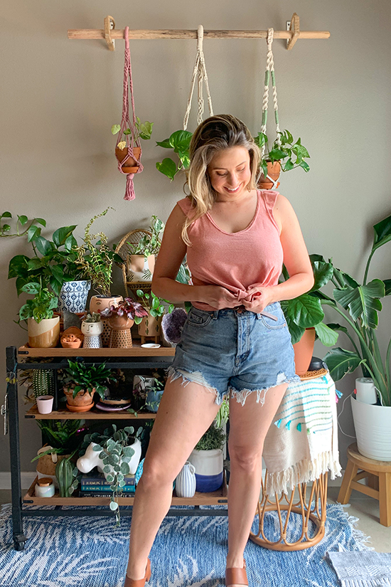 Olivia wears a pink Pony Tank with ruffle arm band and jean shorts.