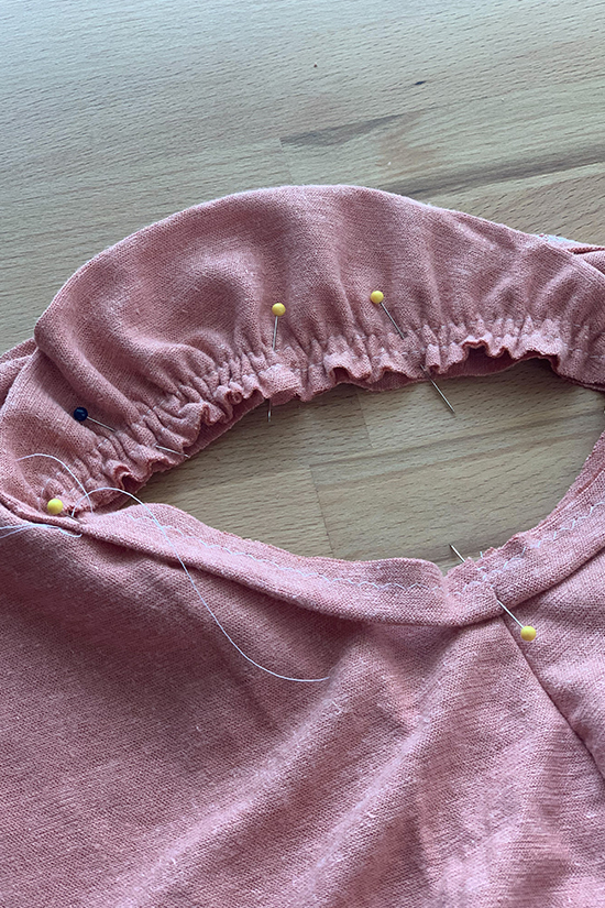 A pink ruffle band is shown pinned to the armhole of a pony tank.
