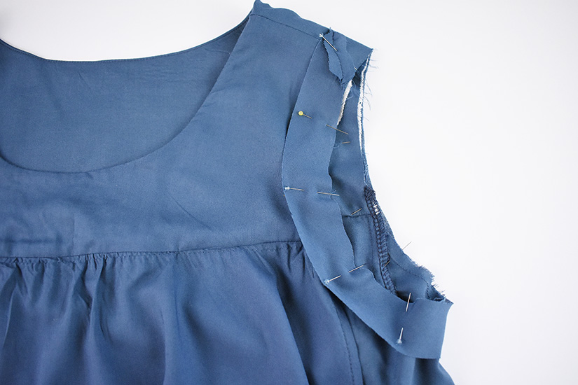 The armhole bias is shown pinned to the right side of the Farrah Blouse and Dress pattern.