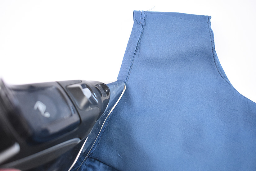 An iron presses bias to the inside of the Farrah blouse.