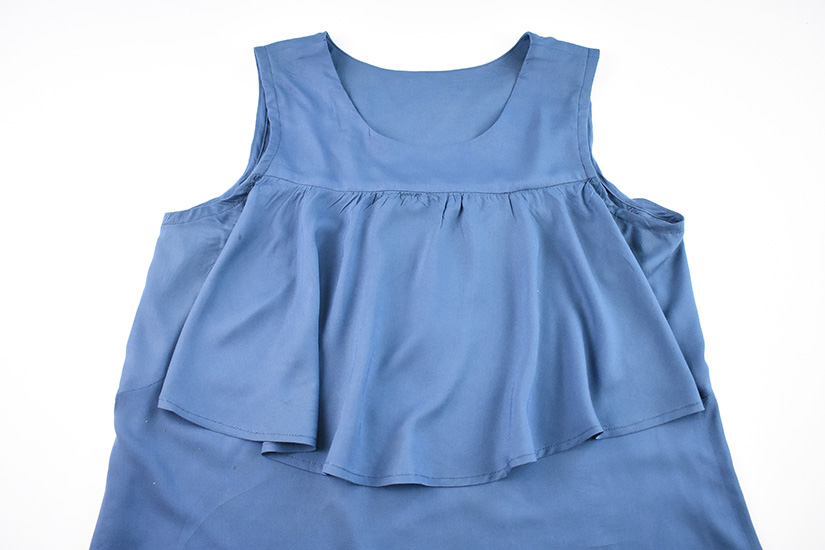 A flat lay of the front ruffle view of the Farrah Blouse and Dress pattern. 