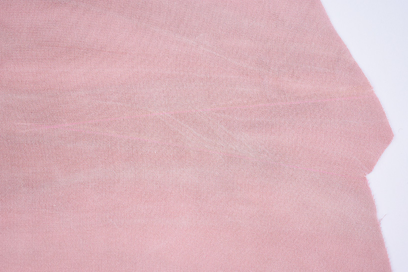 Faint dart marking lines can be seen on pink fabric.