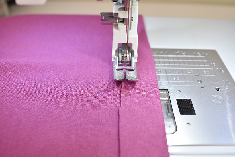 A sewing machine with single needle is shown sewing a zig zag stitch.