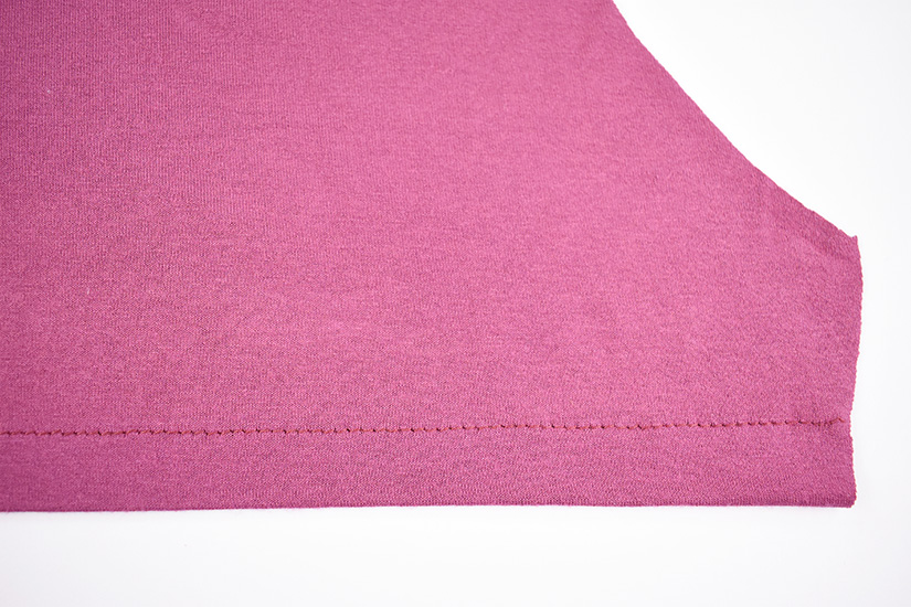 A long straight stitch hem is shown sewn. 