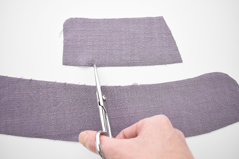 Scissors snip into fabric pieces for the Evelyn Skirt.
