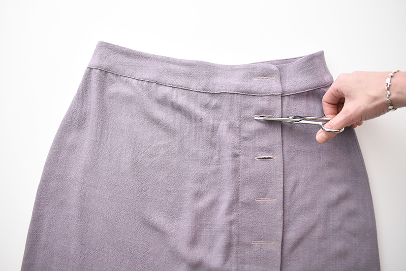 Small scissors open the buttonholes of the Evelyn Skirt. 