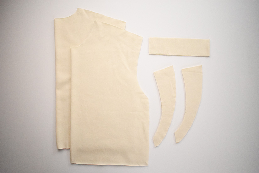 Cut fabrics for the Max Tee sewing pattern are shown on a white background. 