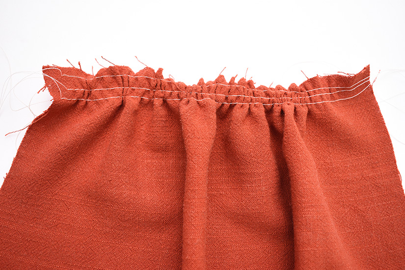 A section of gathered orange fabric