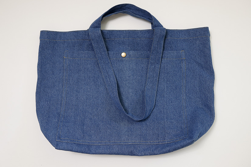 A finished Sun tote with attached snap is shown on a white background. 