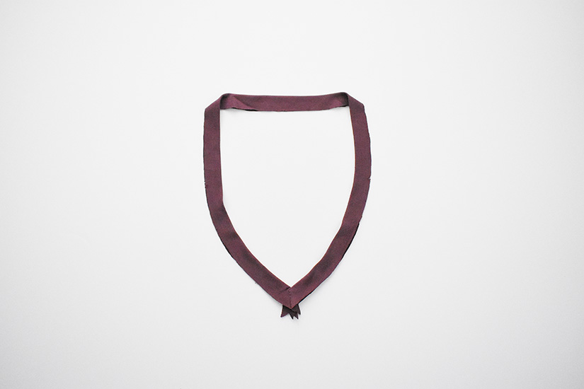 The Pony Tank neckband piece is shown pressed in half and sewn at center front. 