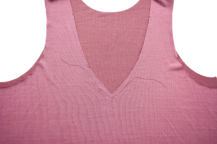 A close up of the neckline on the Pony Tank shows stitching at the center front. 