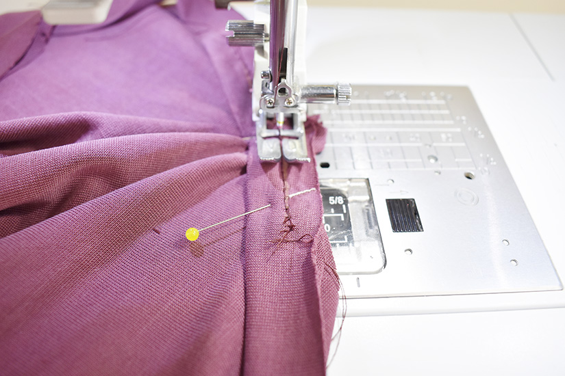 A sewing machine stitches the center front 'v' of the Pony Tank.
