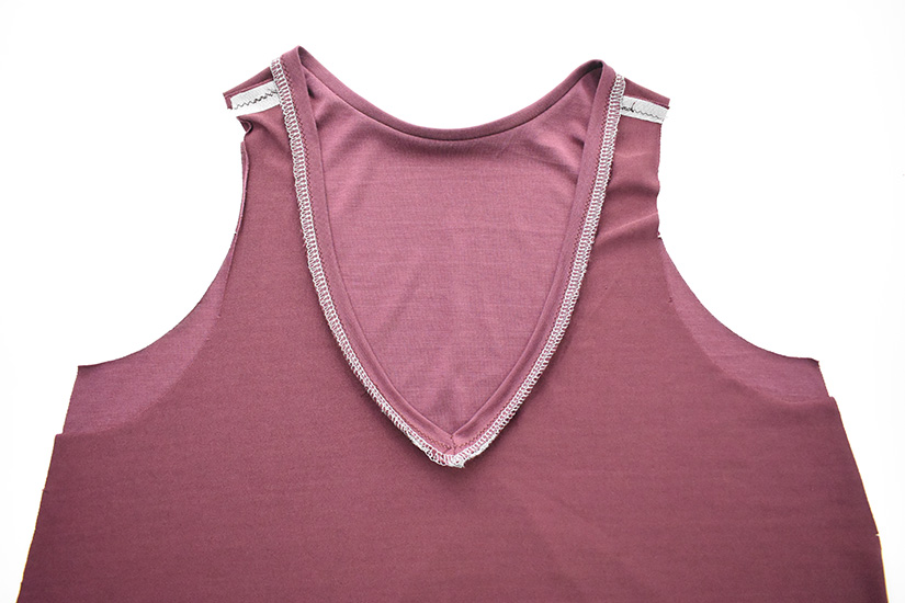 The remaining neckband is sewn to the Pony Tank at center front.