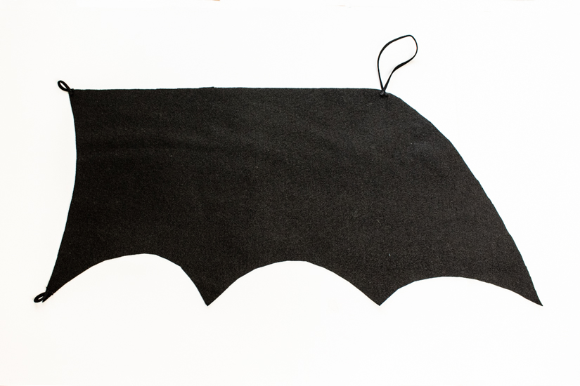A DIY Bat halloween costume wing is shown on a white background. 