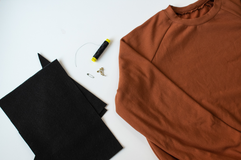 Supplies to make a DIY Jack o'Lantern Halloween Costume are laid on a white background.
