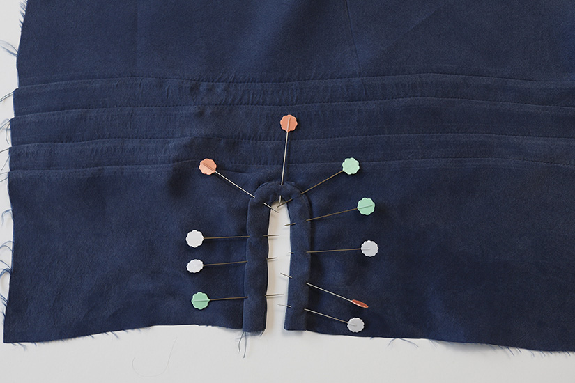 The sleeve placket facing is inside the fabric and pinned. 