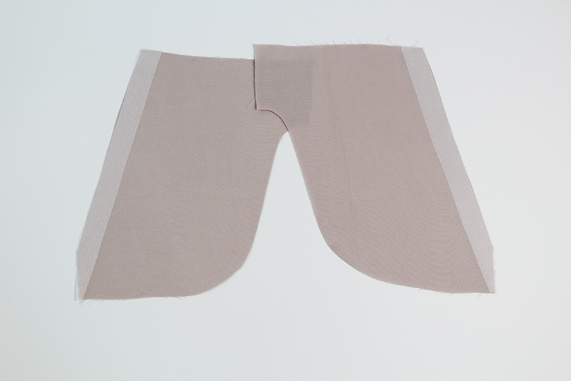 Interfacing is pressed to the pocket lining edges.