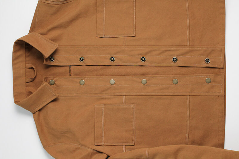 Snaps are shown attached to the Den Jacket. 